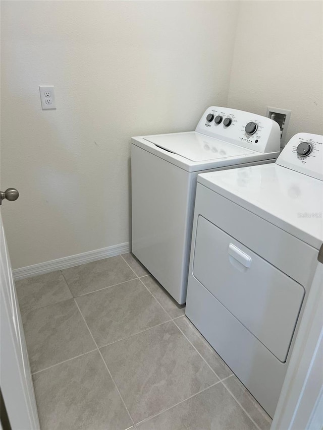 laundry room with light tile patterned flooring and independent washer and dryer