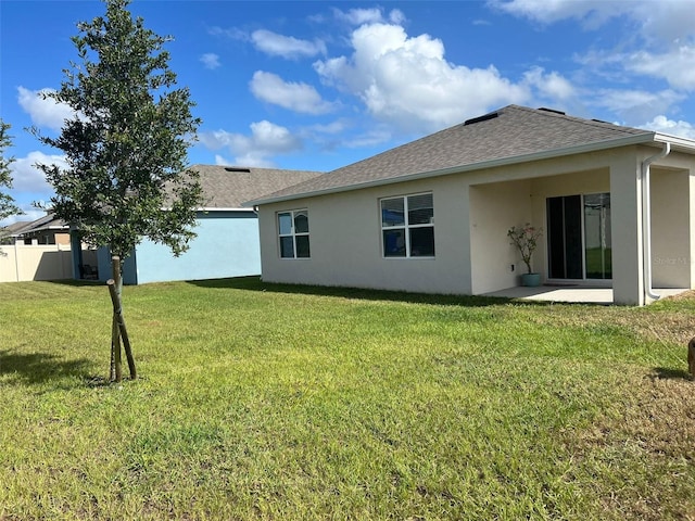 back of property featuring a yard