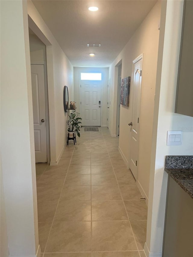 hallway featuring light tile patterned floors