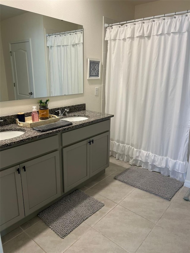 bathroom featuring tile patterned floors, shower / tub combo with curtain, and vanity