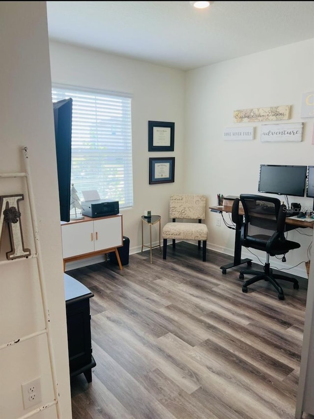 office space with wood finished floors and baseboards