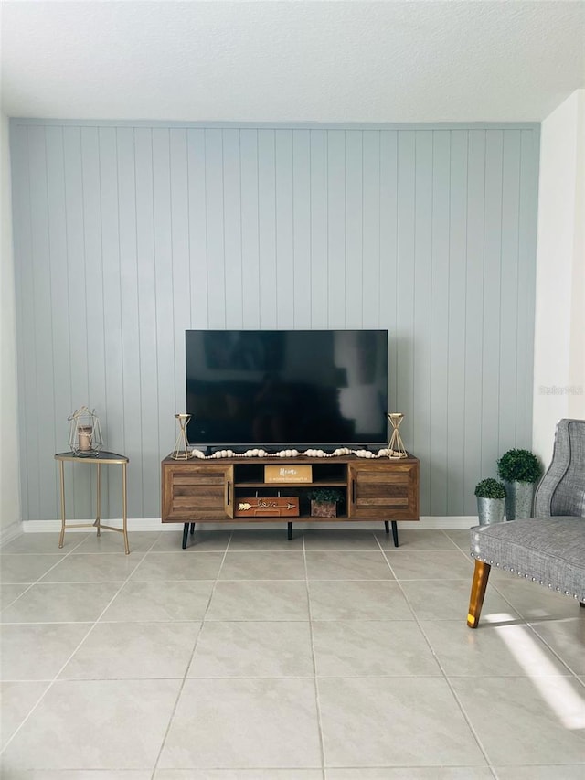 living area with light tile patterned floors and baseboards