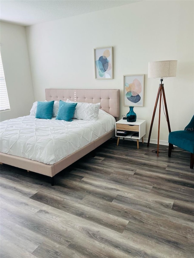 bedroom featuring baseboards and wood finished floors