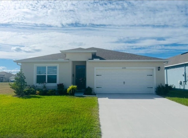 view of front of house with a garage, driveway, a front lawn, and stucco siding