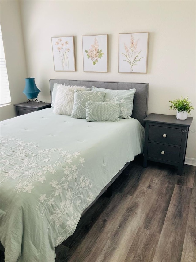 bedroom with dark wood-style flooring