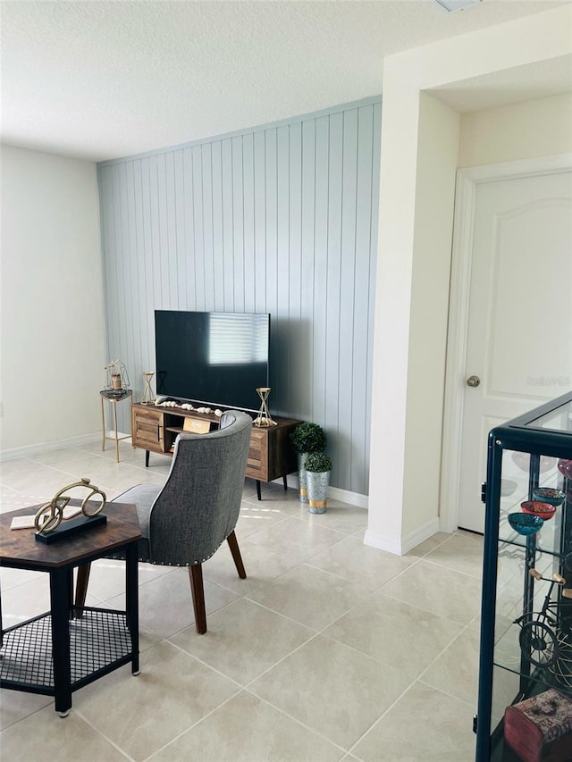 living area with light tile patterned floors and baseboards