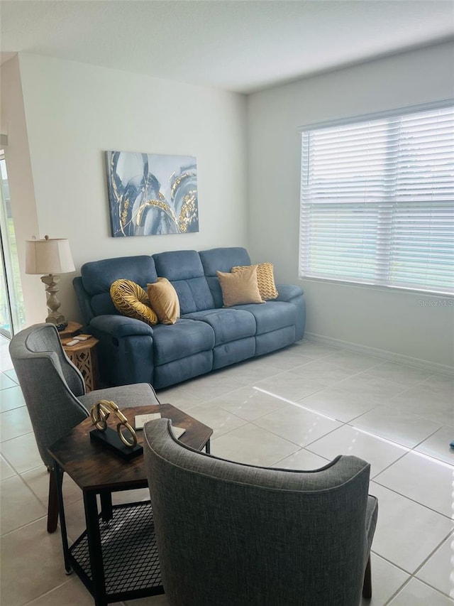 living room featuring baseboards and tile patterned flooring