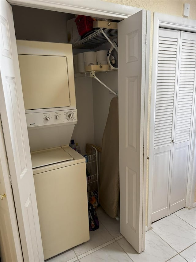 washroom featuring stacked washer / dryer