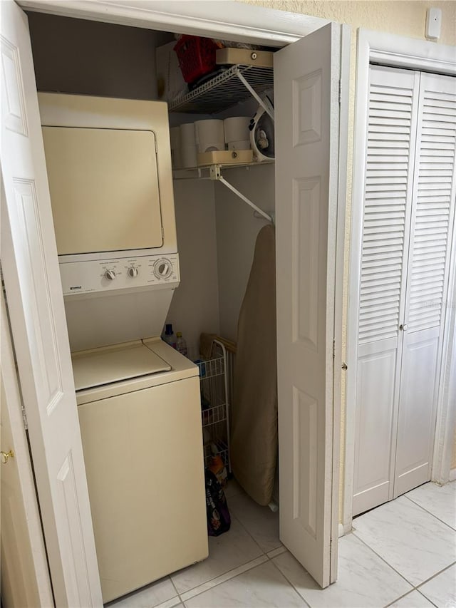 2520 Woodgate Blvd Unit 202, Orlando, FL 32822 - laundry area with estacked washer and dryer and light marble finish flooring