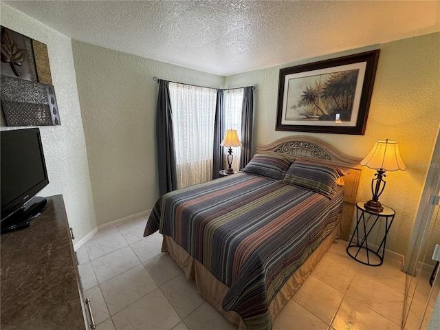 tiled bedroom with a textured ceiling