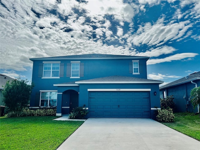 front of property with a front yard and a garage