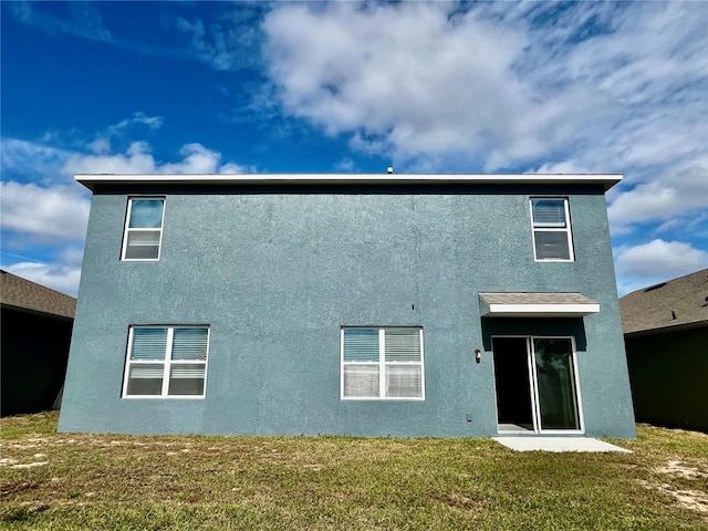 rear view of property with a yard