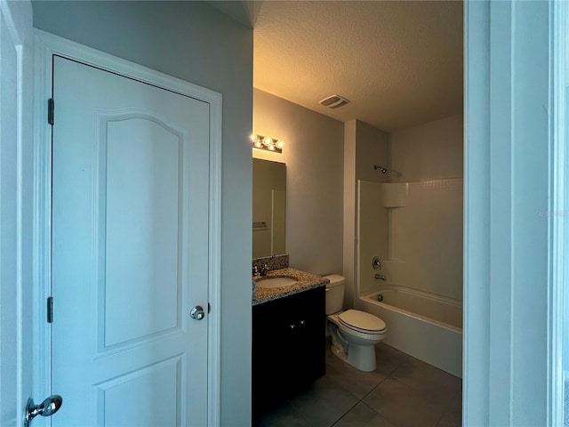 full bathroom featuring vanity, shower / washtub combination, tile patterned flooring, toilet, and a textured ceiling