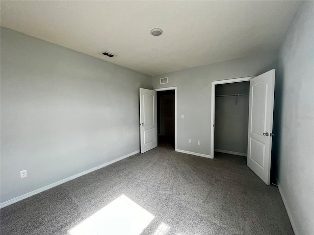 unfurnished bedroom with a closet and carpet floors