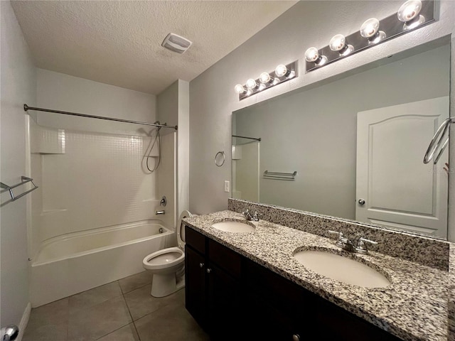 full bathroom featuring tile patterned floors, vanity, a textured ceiling,  shower combination, and toilet