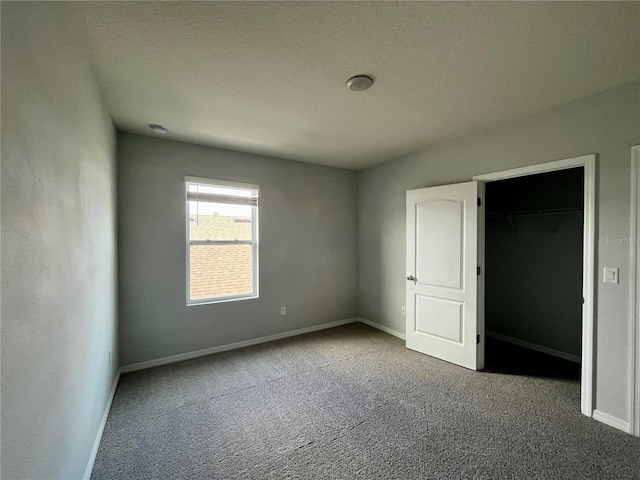 empty room featuring a textured ceiling and carpet floors