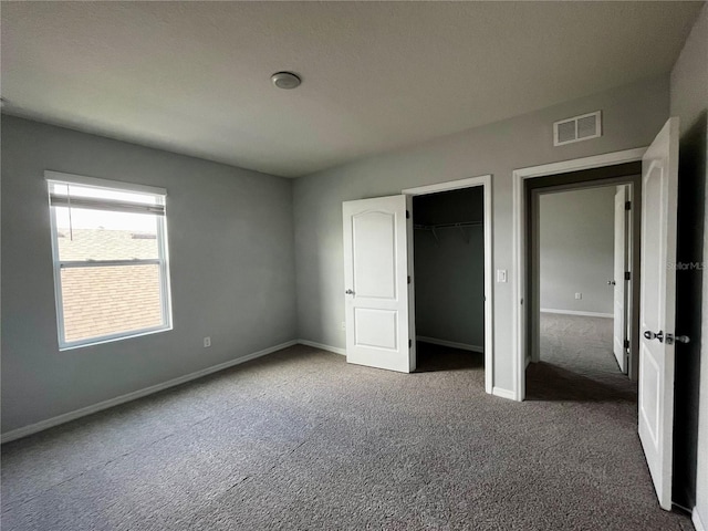 unfurnished bedroom with a closet and carpet