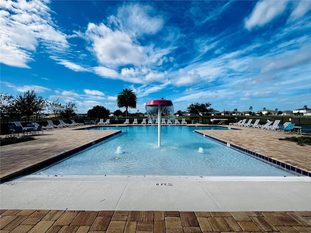 view of swimming pool featuring pool water feature and a patio