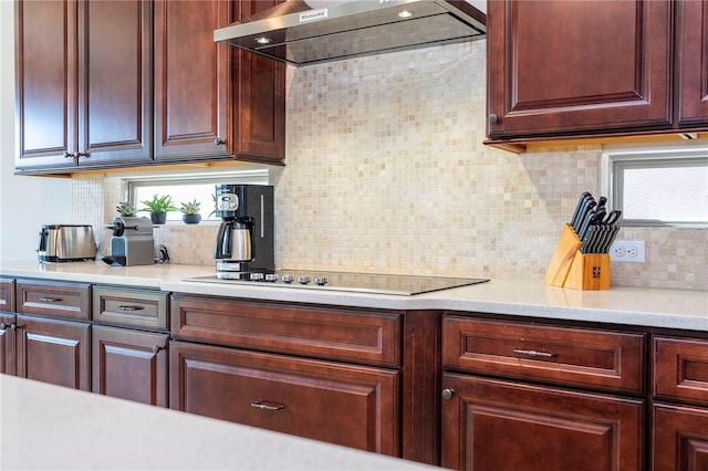 kitchen with backsplash, black electric stovetop, and extractor fan