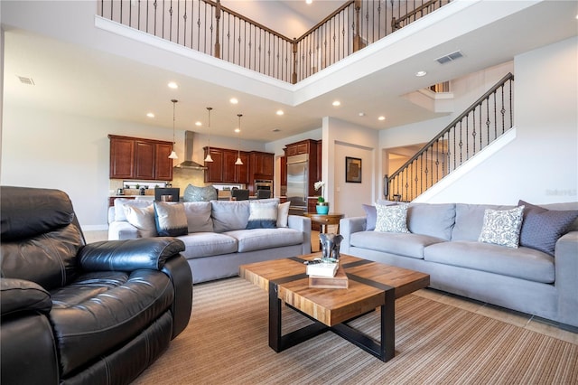 living room featuring a towering ceiling