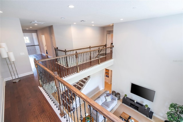 stairway with hardwood / wood-style floors