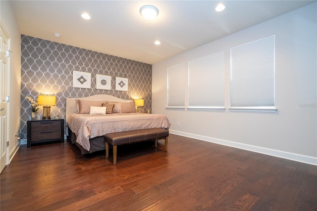 bedroom with dark hardwood / wood-style floors