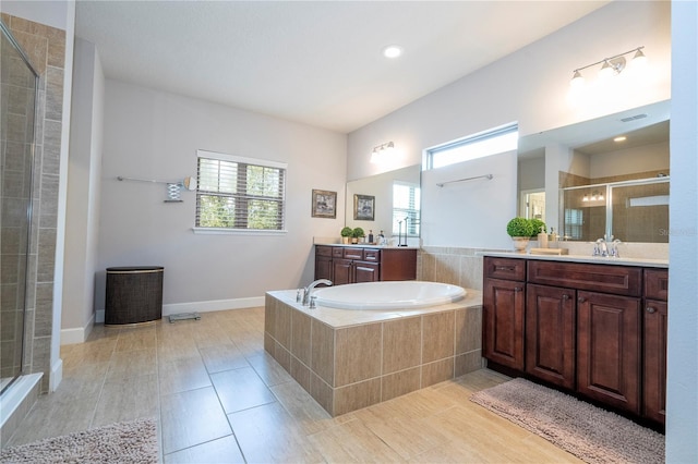 bathroom with plenty of natural light, shower with separate bathtub, and vanity