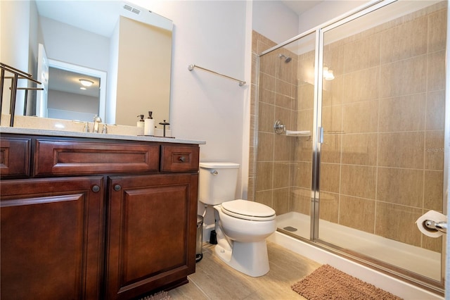 bathroom with vanity, toilet, and walk in shower