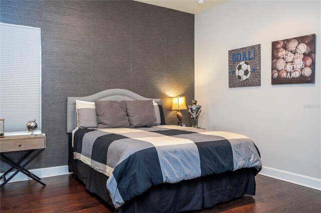 bedroom with dark hardwood / wood-style flooring