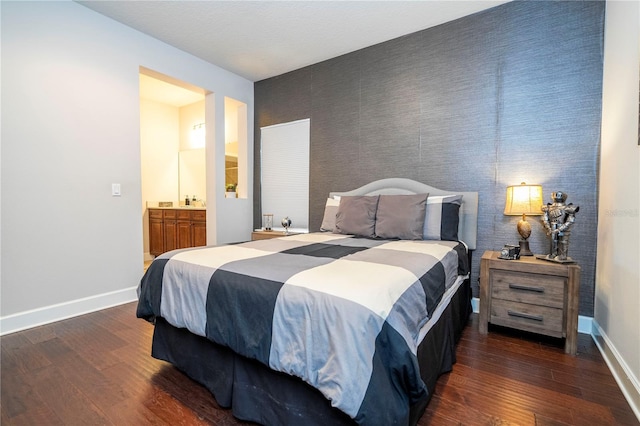 bedroom featuring dark hardwood / wood-style flooring and ensuite bathroom