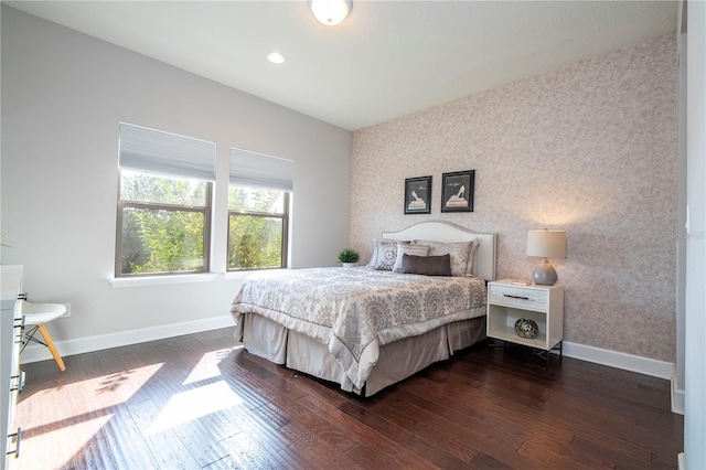 bedroom with dark hardwood / wood-style flooring