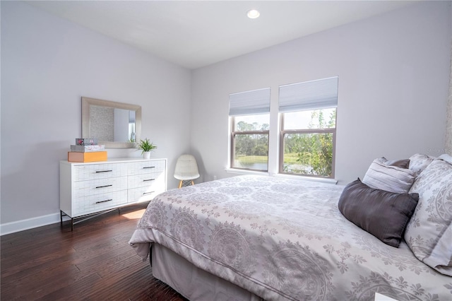 bedroom with dark wood-type flooring