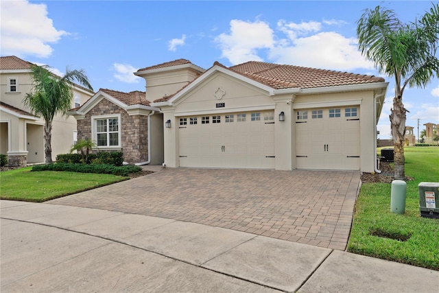 mediterranean / spanish-style house with a front lawn and a garage