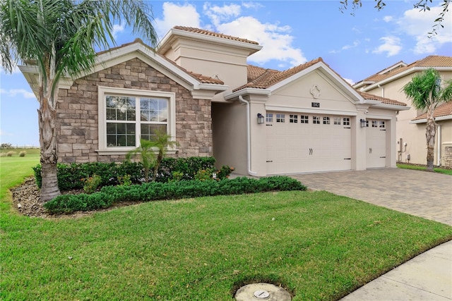 mediterranean / spanish-style home featuring a garage and a front lawn