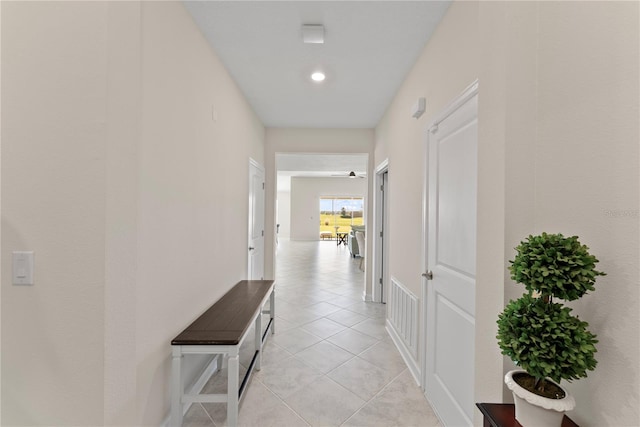 hall featuring light tile patterned flooring