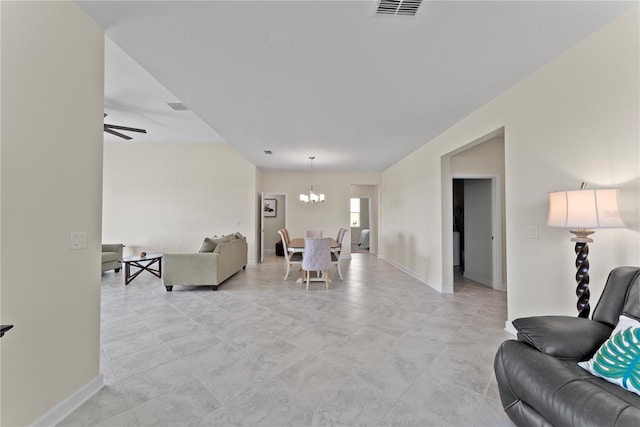 living room featuring ceiling fan with notable chandelier