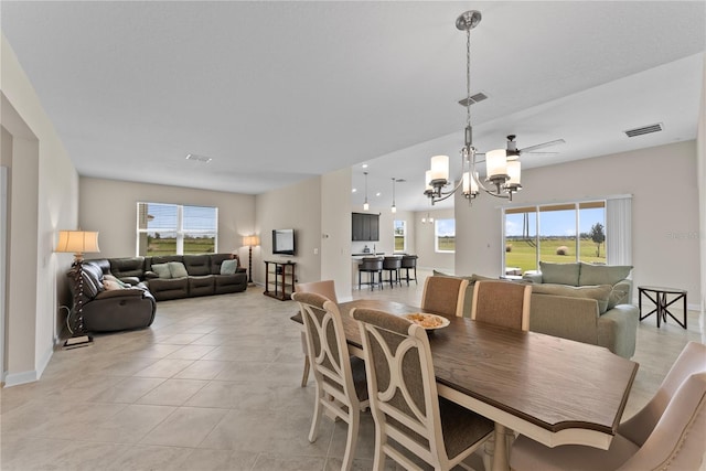 dining room featuring an inviting chandelier, plenty of natural light, and light tile patterned flooring