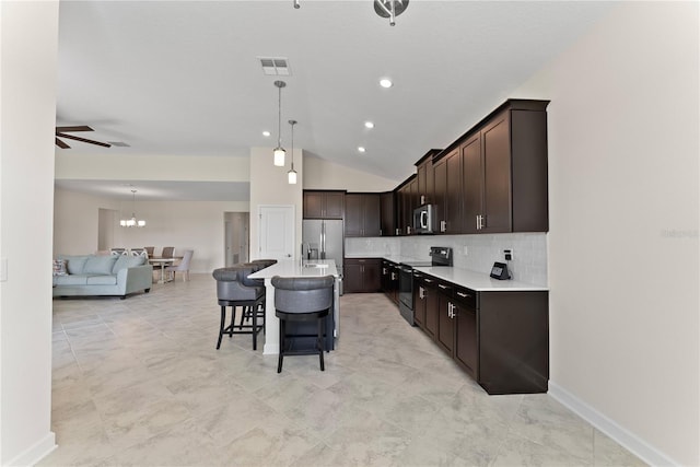 kitchen featuring a breakfast bar, dark brown cabinetry, stainless steel appliances, a center island, and hanging light fixtures