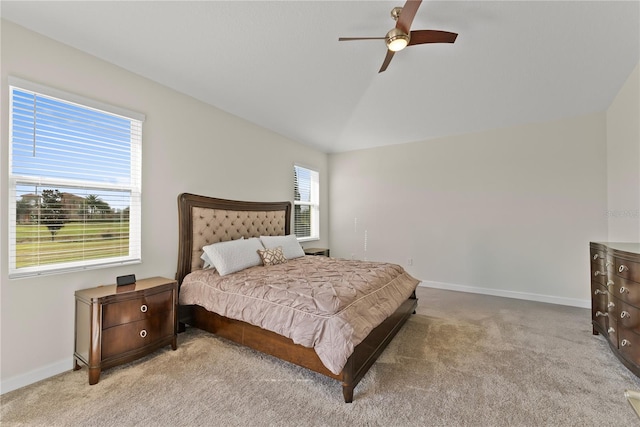 bedroom with ceiling fan, light carpet, and vaulted ceiling