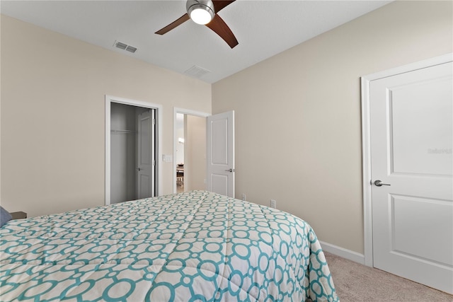 bedroom featuring ceiling fan, light colored carpet, and a closet