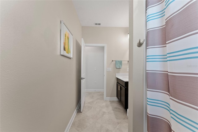 bathroom with vanity and curtained shower