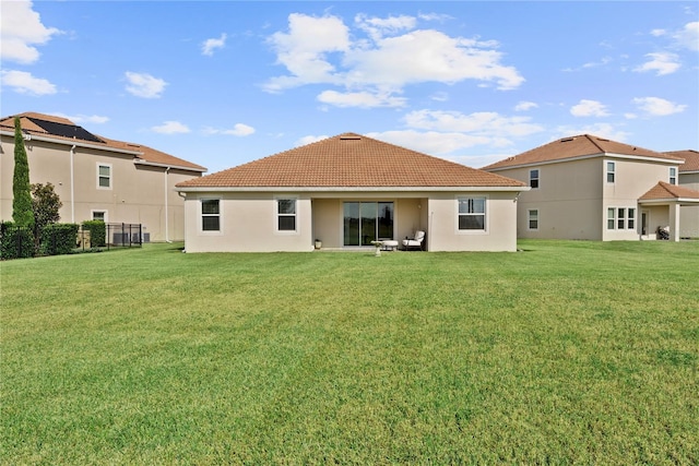 back of house with a lawn