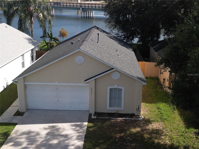 view of front of home featuring a garage and a water view