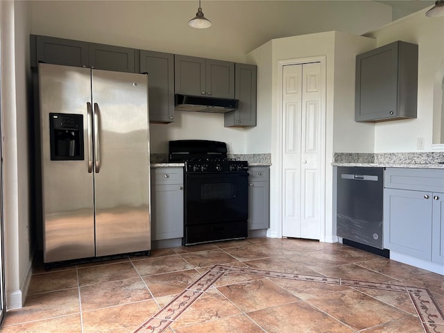 kitchen with light stone countertops, appliances with stainless steel finishes, and gray cabinets