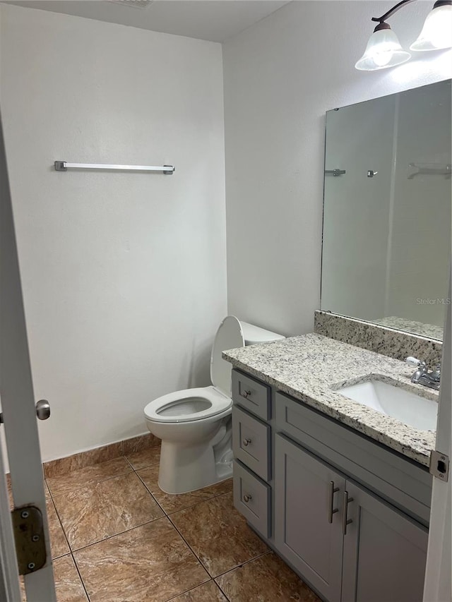 bathroom with tile patterned floors, vanity, and toilet