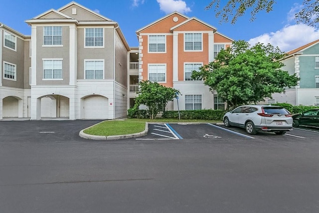12843 Madison Pointe Cir Unit 107, Orlando, FL 32821 - view of front of property featuring stucco siding and uncovered parking