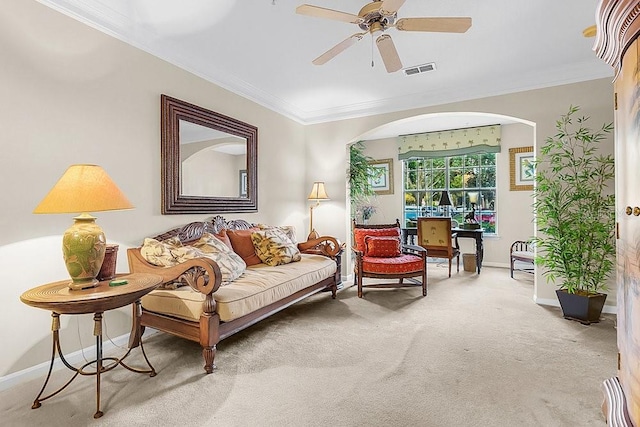 carpeted living room featuring ceiling fan and ornamental molding