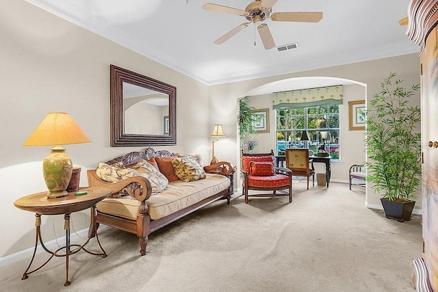 12843 Madison Pointe Cir Unit 107, Orlando, FL 32821 - living area featuring light carpet, arched walkways, ornamental molding, and a ceiling fan