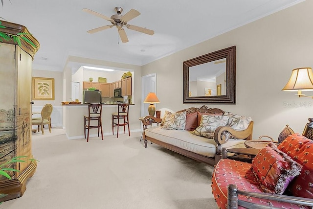 carpeted living room with ceiling fan and ornamental molding