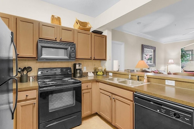 12843 Madison Pointe Cir Unit 107, Orlando, FL 32821 - kitchen featuring black appliances, tasteful backsplash, and light countertops